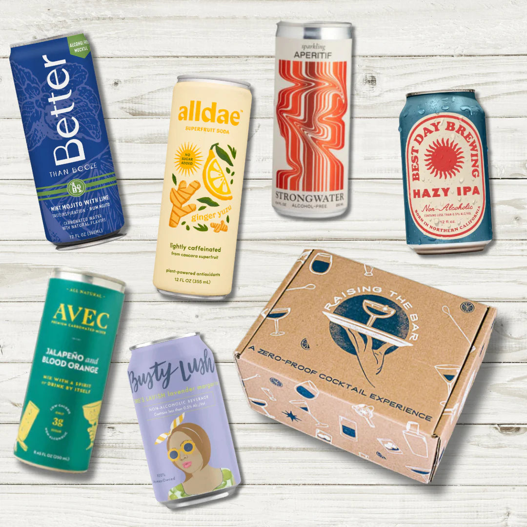 Various non-alcoholic cans scattered on wood background.
