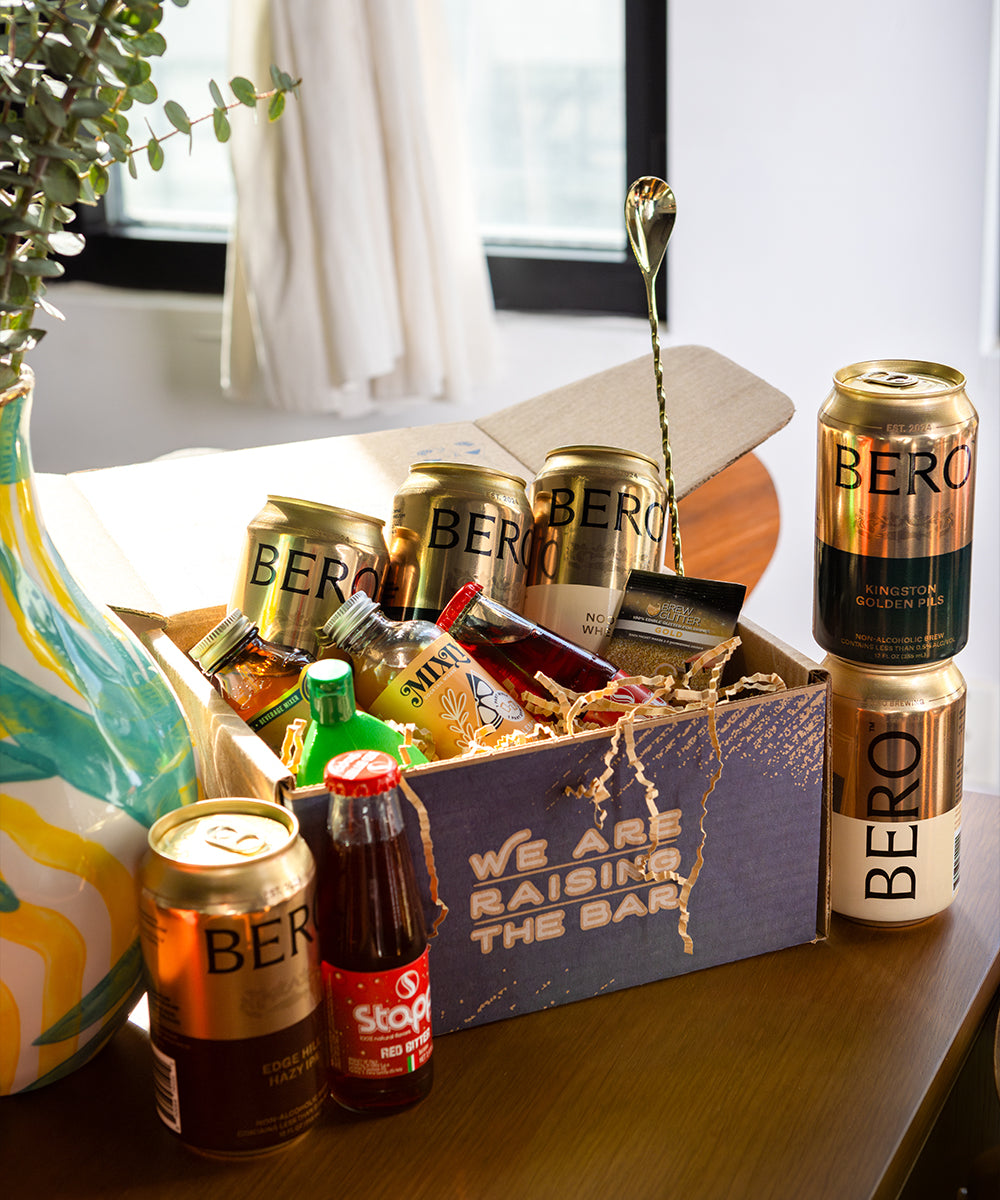 Gold Standard box open with various non-alcoholic cocktail ingredients.