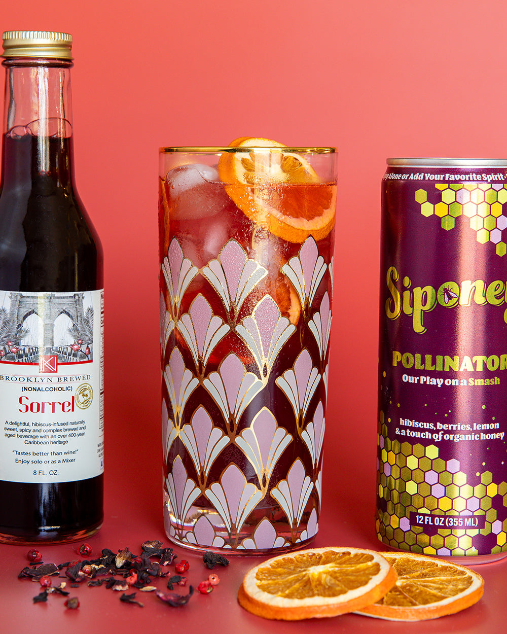 Various zero-proof cocktails on red surface.
