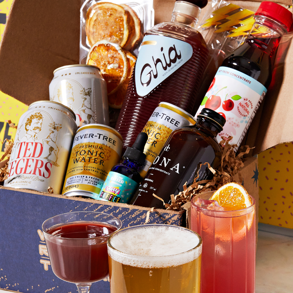 Alcohol-themed gift box with drinks and bottles on a wooden surface