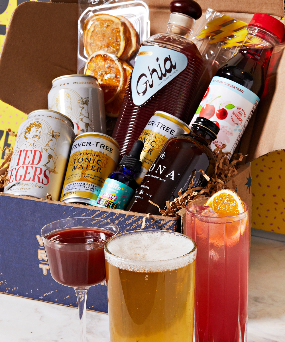 Alcohol-themed gift box with drinks and bottles on a wooden surface