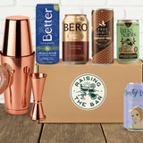 Various non-alcoholic cocktail cans with bar shaker and box